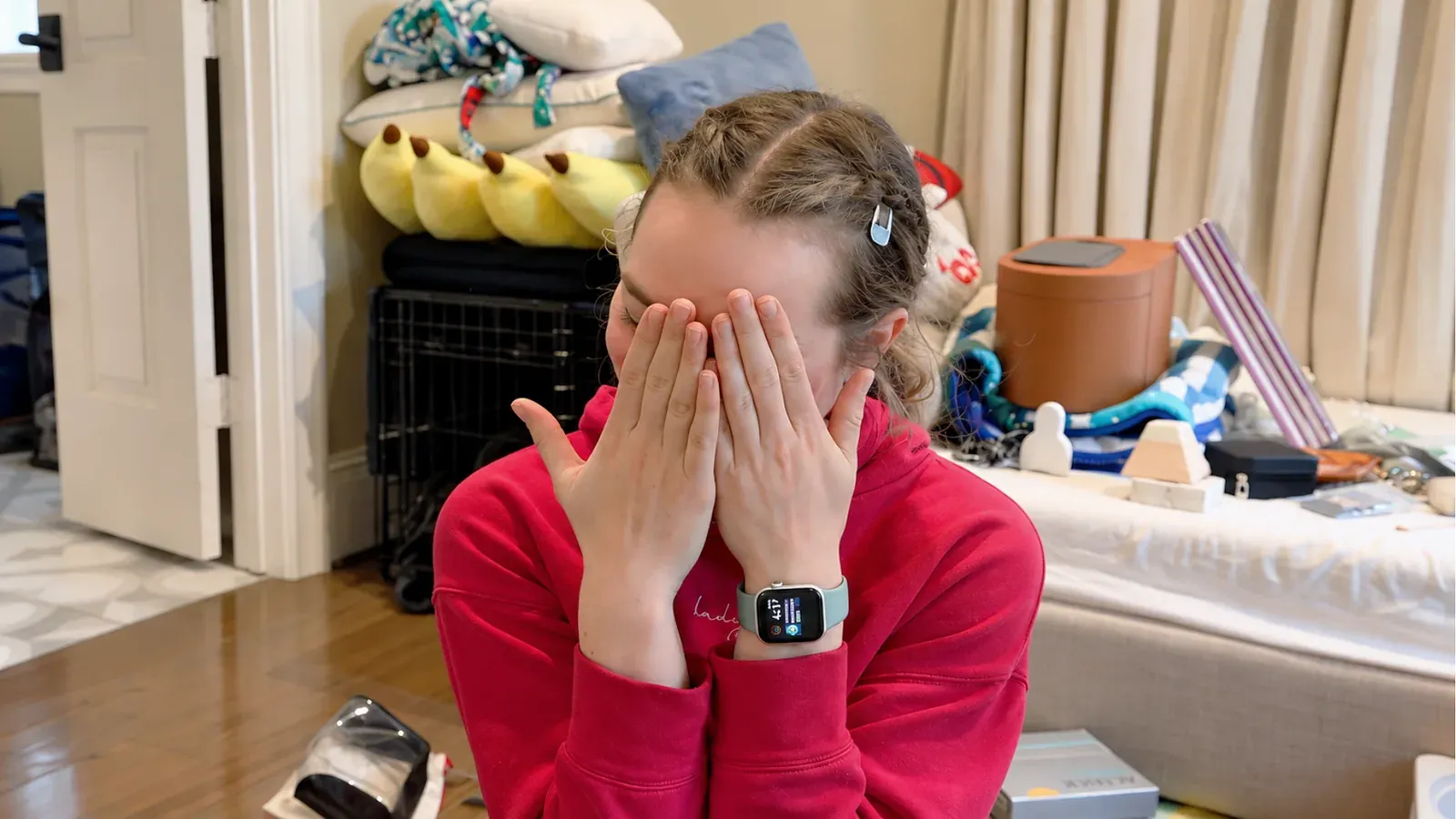 An actor covers her face with both hands in a comedic scene